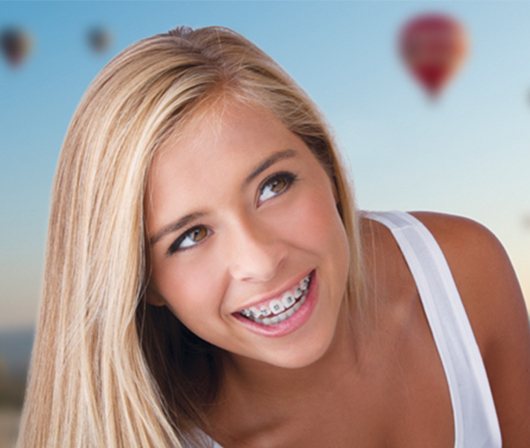 Blonde teen girl smiling with braces