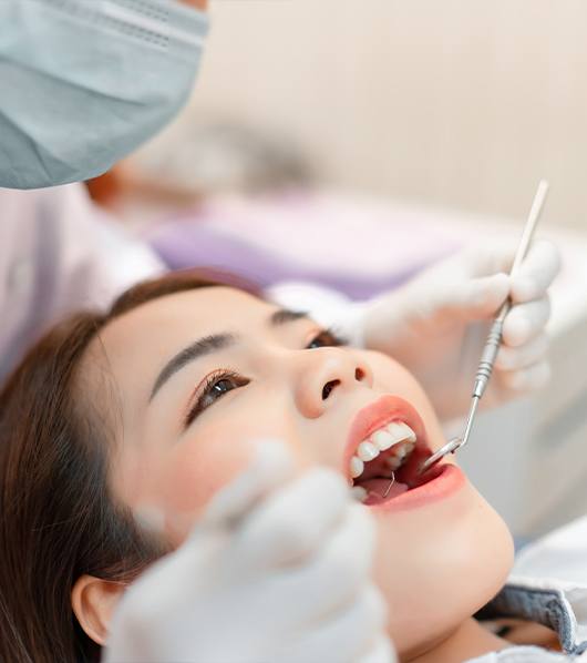 woman laying back in orthodontic exam chair