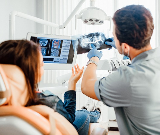Lakewood Orthodontist pointing to patient's X-ray