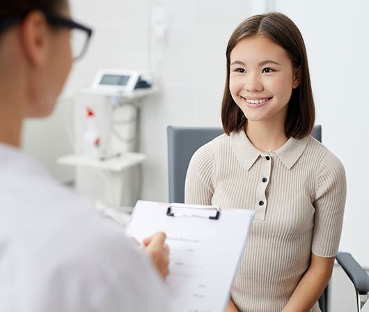 young female patient smiling at dentist