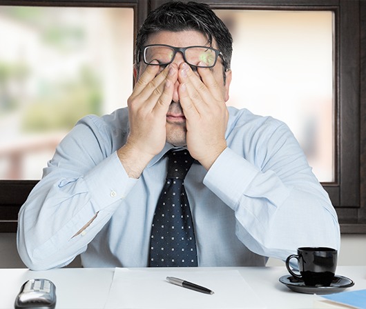 man covering eyes tired in need of airway management treatment