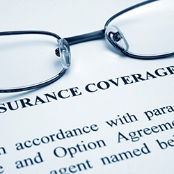 Glasses and document detailing insurance coverage information