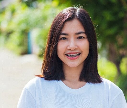 Girl smiling with braces in Dallas