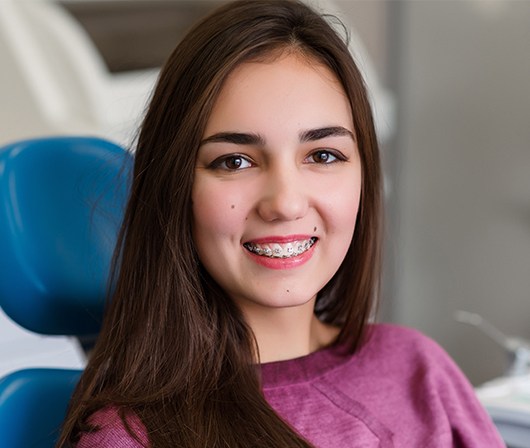 girl in maroon sweater with braces smiling