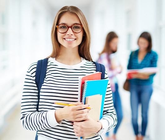 girl with glasses at school smiling