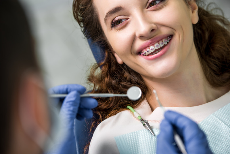 Patient smiling at orthodontist with braces